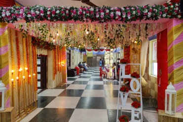 The hall is decorated for an event, featuring floral arrangements, a 