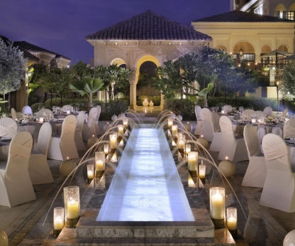 Everyone set up gracefully displayed wedding reception tables and chairs in a roomy banquet.
