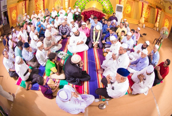 People in a room shared moments of connection and celebration, indicative of a Muslim wedding.