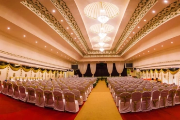 A spacious mahal with elegant chairs and tables, perfect for hosting weddings and special events