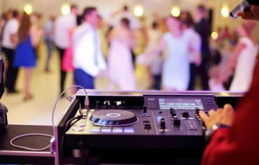 A joy of DJ music at a wedding reception, creating an energetic and vibrant atmosphere for guests.