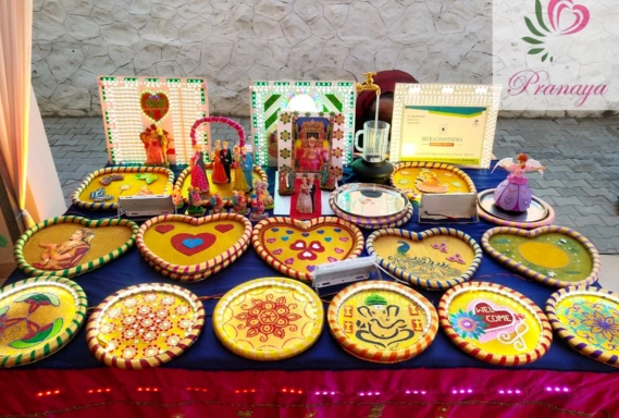 Many colorful decorative thalis and festive items are displayed for an Indian festive celebration.