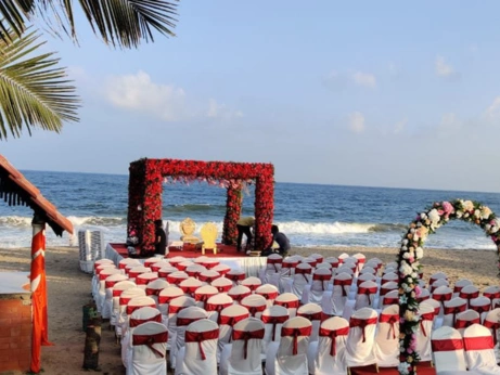 Beautiful beach wedding setup with elegant chairs and vibrant flowers highlights top event management