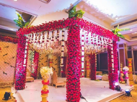 Lush flowers and flickering candles decorated a stunning wedding stage, setting an intimate scene.