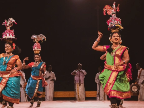 A women in saris perform the karagattam dance, showcasing cultural heritage and their celebration.