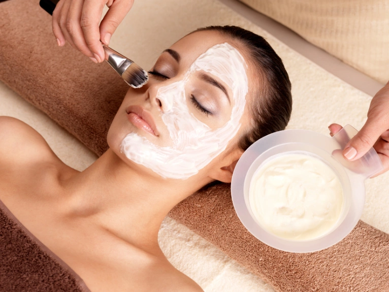 A bride enjoys a soothing facial mask treatment in a tranquil spa, enhancing her bridal glow.