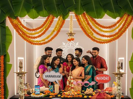 During a wedding in Kerala, India, the groom gets his makeup applied amidst vibrant decorations