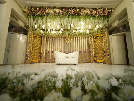 A decorated archway, adorned with flowers and a lotus, is ideal for creative wedding decorations.