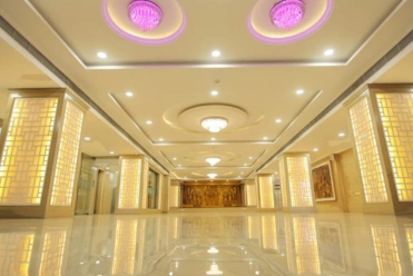 A spacious mahal with elegant chairs and tables, perfect for hosting weddings and special events