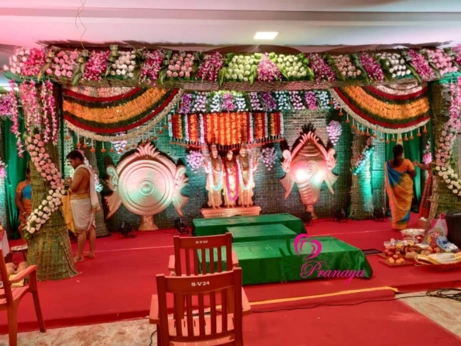 An elegantly decorated wedding stage, adorned with flowers and reflecting a traditional temple theme